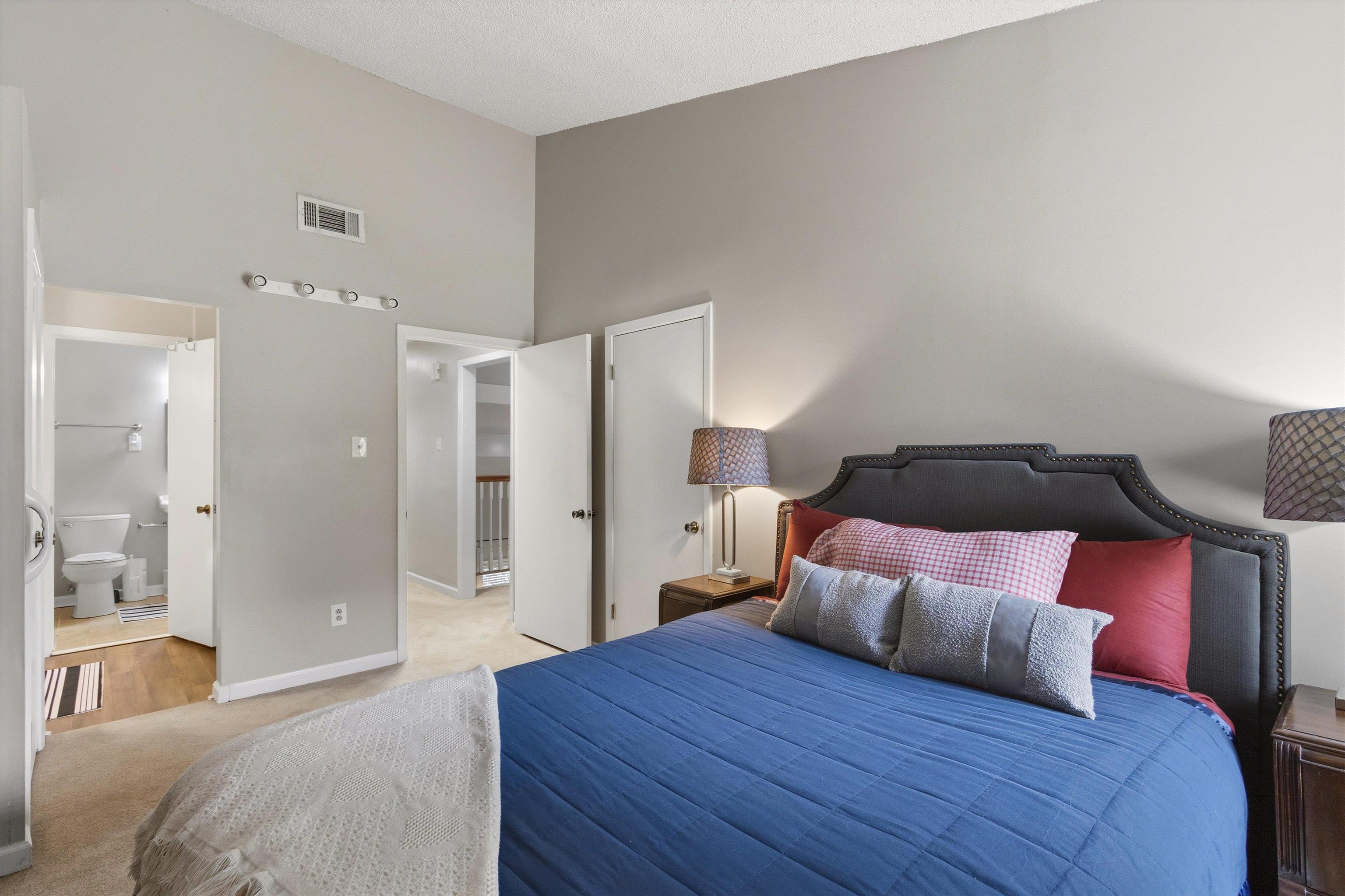 1906 Allenby Road, Unit 16 Germantown, TN 38139 - Photo 19 of 31 Vaulted ceiling, recessed lighting, neutral wall palette, plush carpeting, and an adjoining bathroom with wood-finish flooring