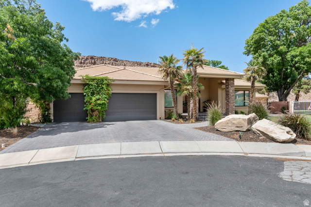 2712 Rio Vista Drive St. George, UT 84790 - Photo 1 of 1 View of front facade with decorative driveway, a garage, stucco siding, stone siding, and a tiled roof