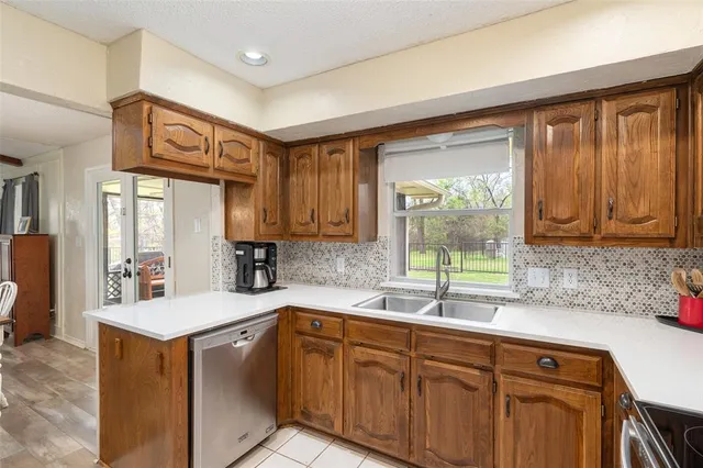 a kitchen with a sink cabinets and window