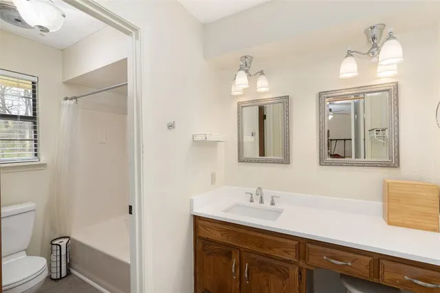 a bathroom with a sink and two mirror