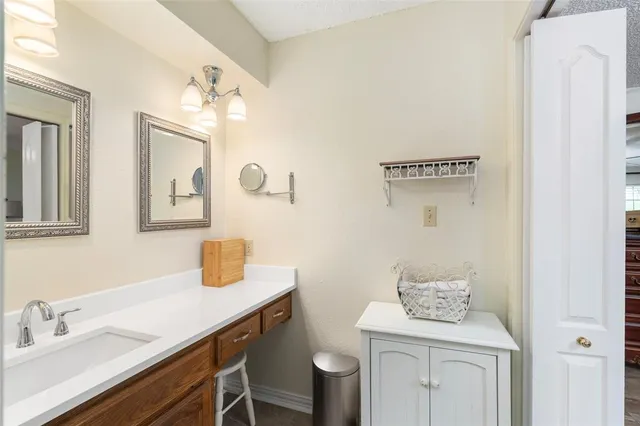 a bathroom with a sink toilet and mirror