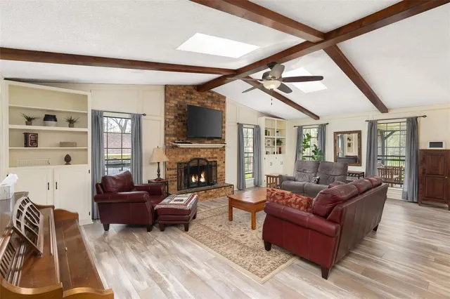 a living room with furniture fireplace and a flat screen tv