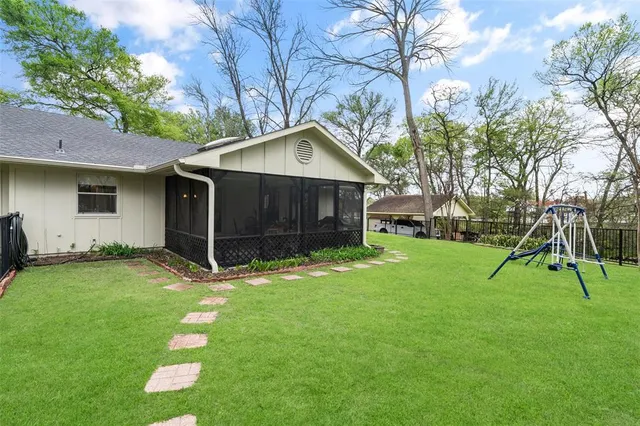 a backyard of a house with table and chairs