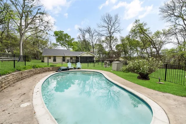 a view of a swimming pool with a garden