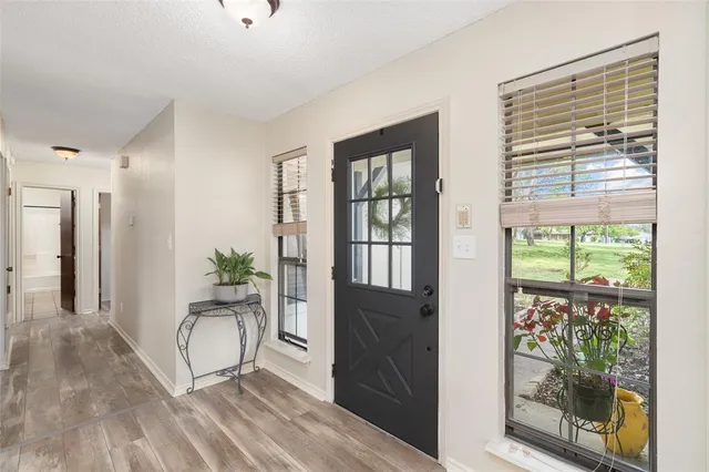 a living room with hardwood floor and windows