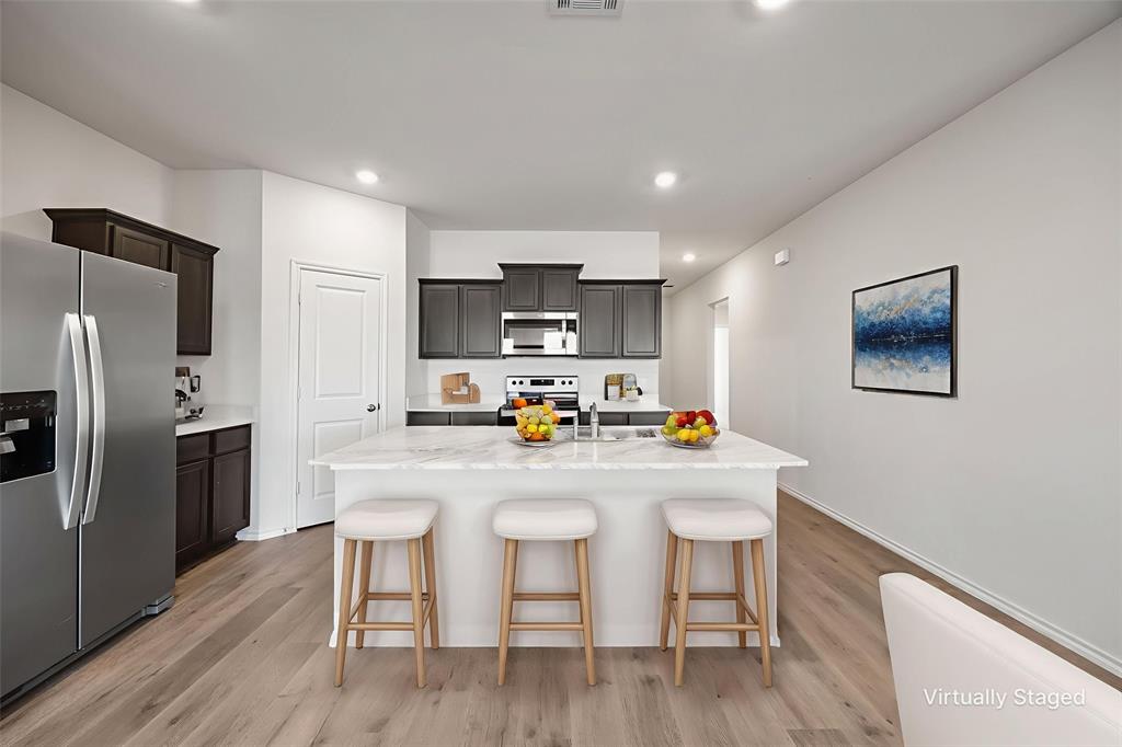 2811 Jasmine Drive Sherman, TX 75092 - Photo 11 of 22 a kitchen with refrigerator cabinets and wooden floor