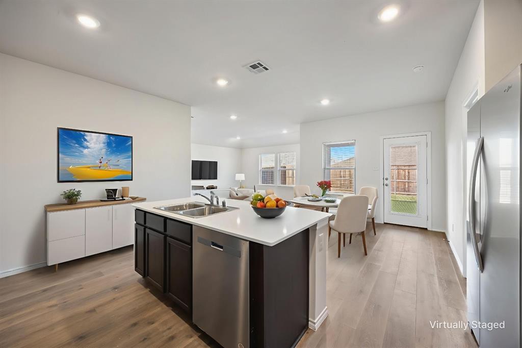 2811 Jasmine Drive Sherman, TX 75092 - Photo 12 of 22 a kitchen with stainless steel appliances granite countertop a table chairs and a refrigerator