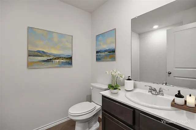 a bathroom with a granite countertop sink mirror and toilet