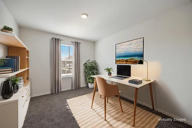 a workspace with furniture and window