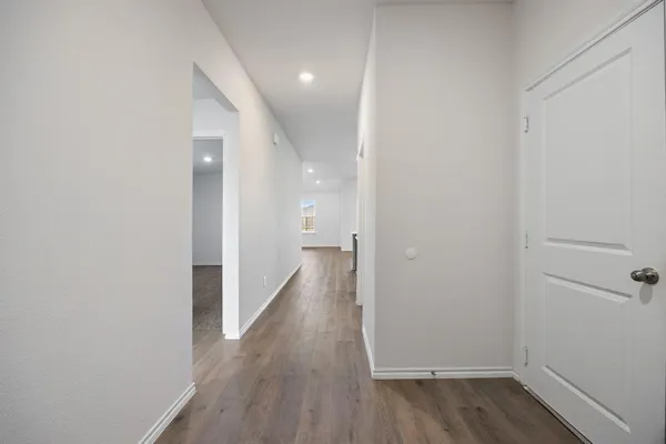 a view of a hallway with wooden floor
