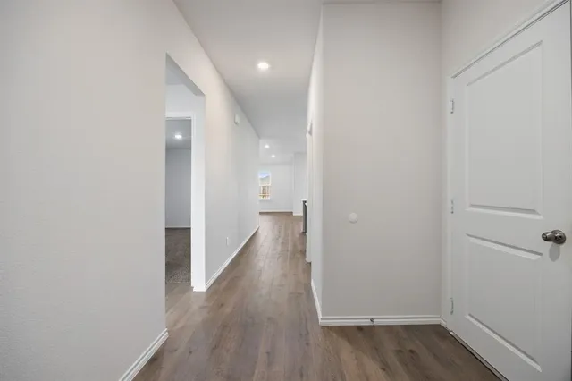 a view of a hallway with wooden floor