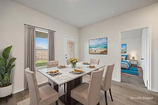 a view of a dining room with furniture window and wooden floor