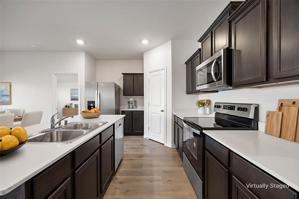 2811 Jasmine Drive Sherman, TX 75092 - Photo 10 of 22 a kitchen with granite countertop a sink counter top space appliances and cabinets