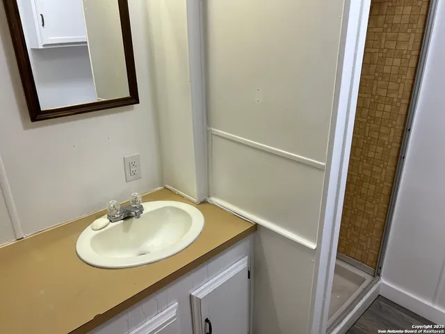 a bathroom with a sink a mirror and a sink
