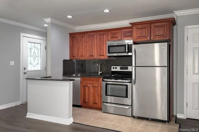 a kitchen with stainless steel appliances granite countertop a refrigerator stove a sink and a microwave