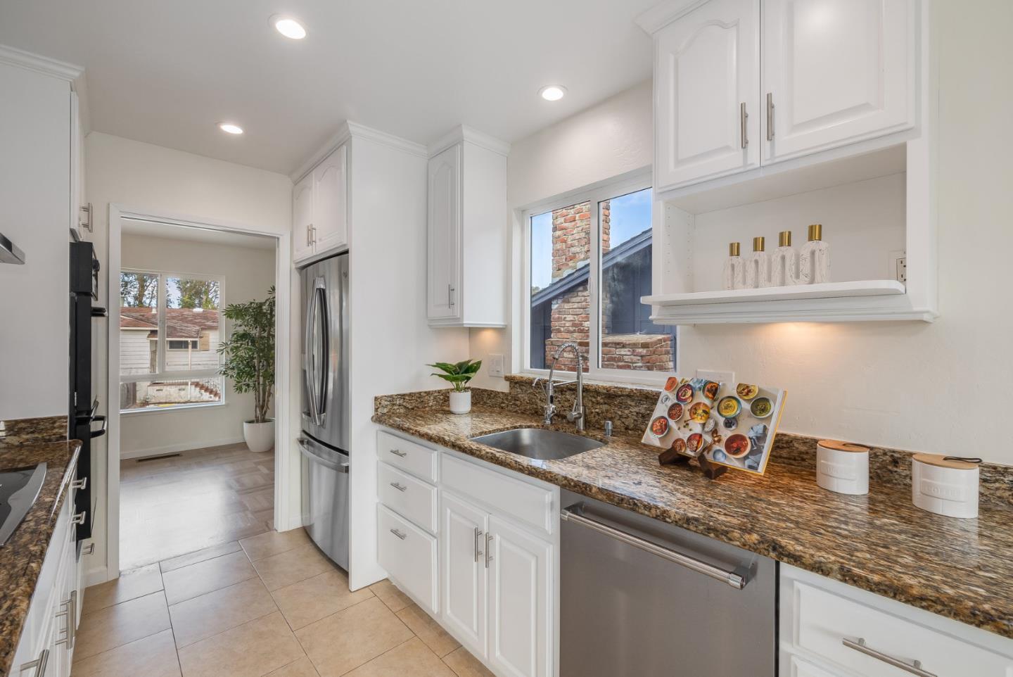 121 Riverside Drive San Bruno, CA 94066 - Photo 12 of 66 a kitchen with stainless steel appliances granite countertop a sink stove and refrigerator