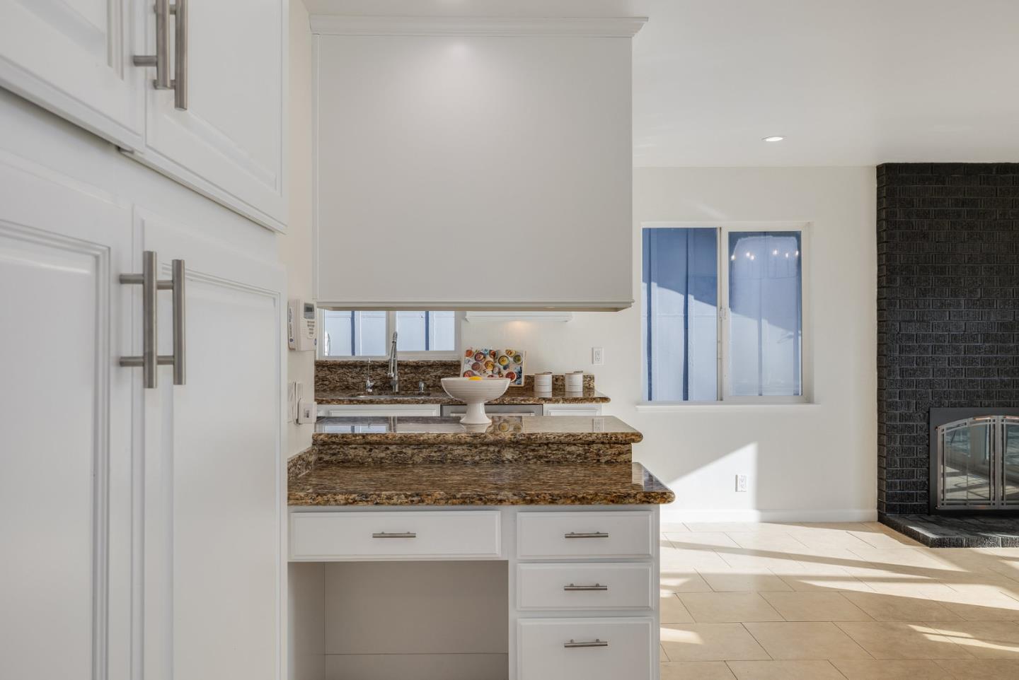 121 Riverside Drive San Bruno, CA 94066 - Photo 19 of 66 a kitchen with kitchen island granite countertop wooden cabinets and a counter top space
