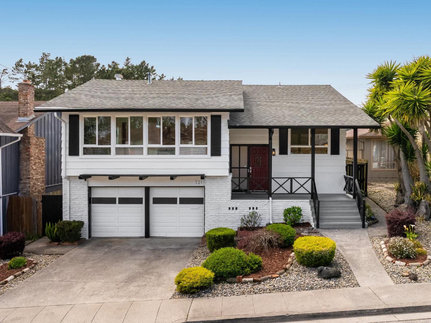 121 Riverside Drive San Bruno, CA 94066 - Photo 2 of 66 a front view of a house with a yard and potted plants