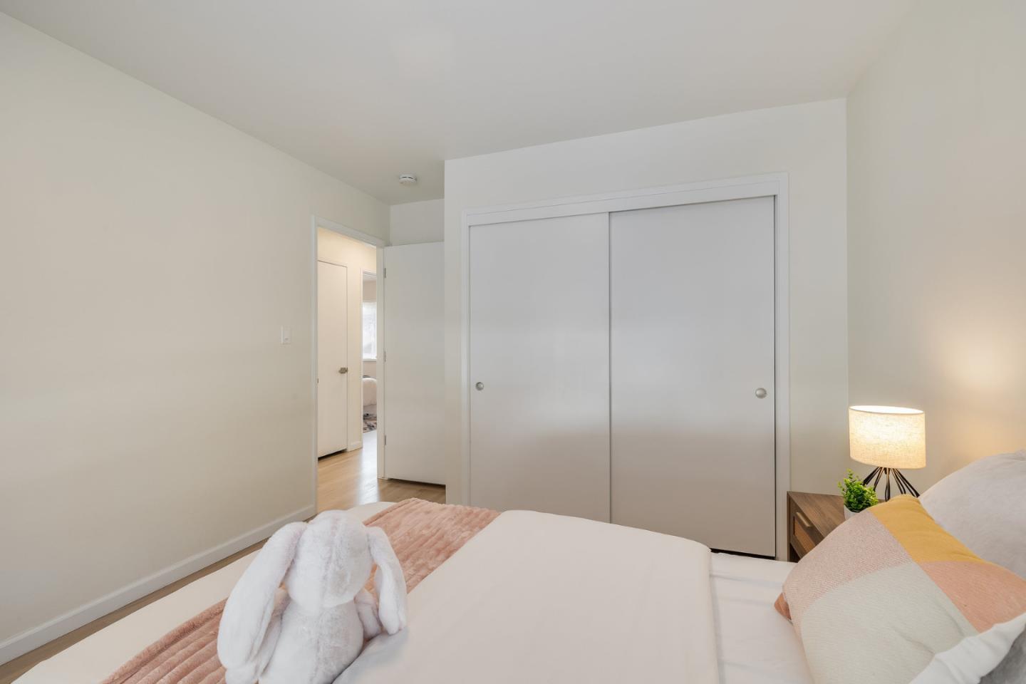 121 Riverside Drive San Bruno, CA 94066 - Photo 21 of 66 a bedroom with a bed and a lamp