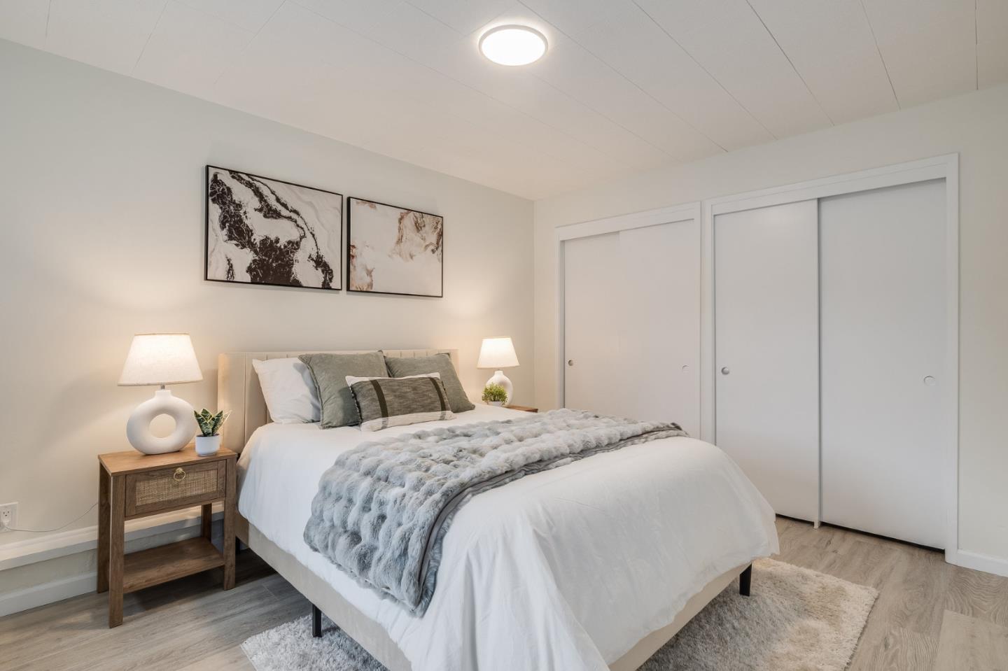 121 Riverside Drive San Bruno, CA 94066 - Photo 26 of 66 a bedroom with a bed and a lamp