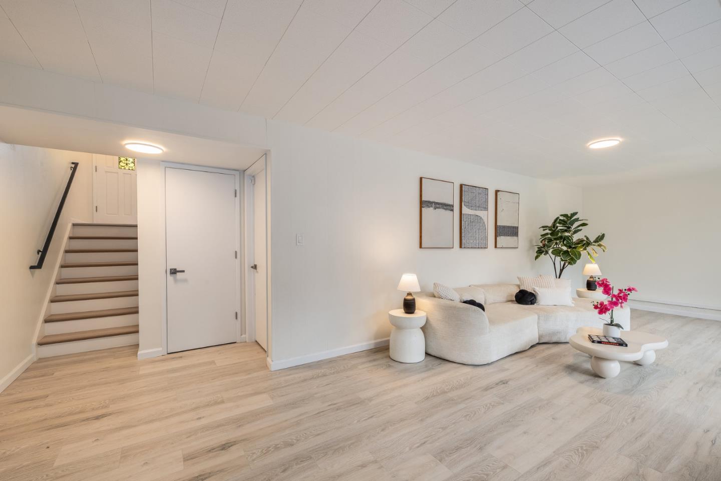 121 Riverside Drive San Bruno, CA 94066 - Photo 37 of 66 a room with wooden floor potted plant and white walls