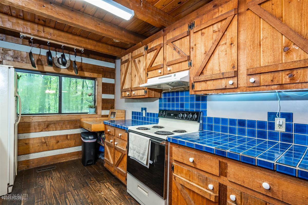 250 Lee King Road Forsyth, GA 31029 - Photo 22 of 31 a kitchen with stainless steel appliances kitchen island granite countertop a sink and wooden cabinets