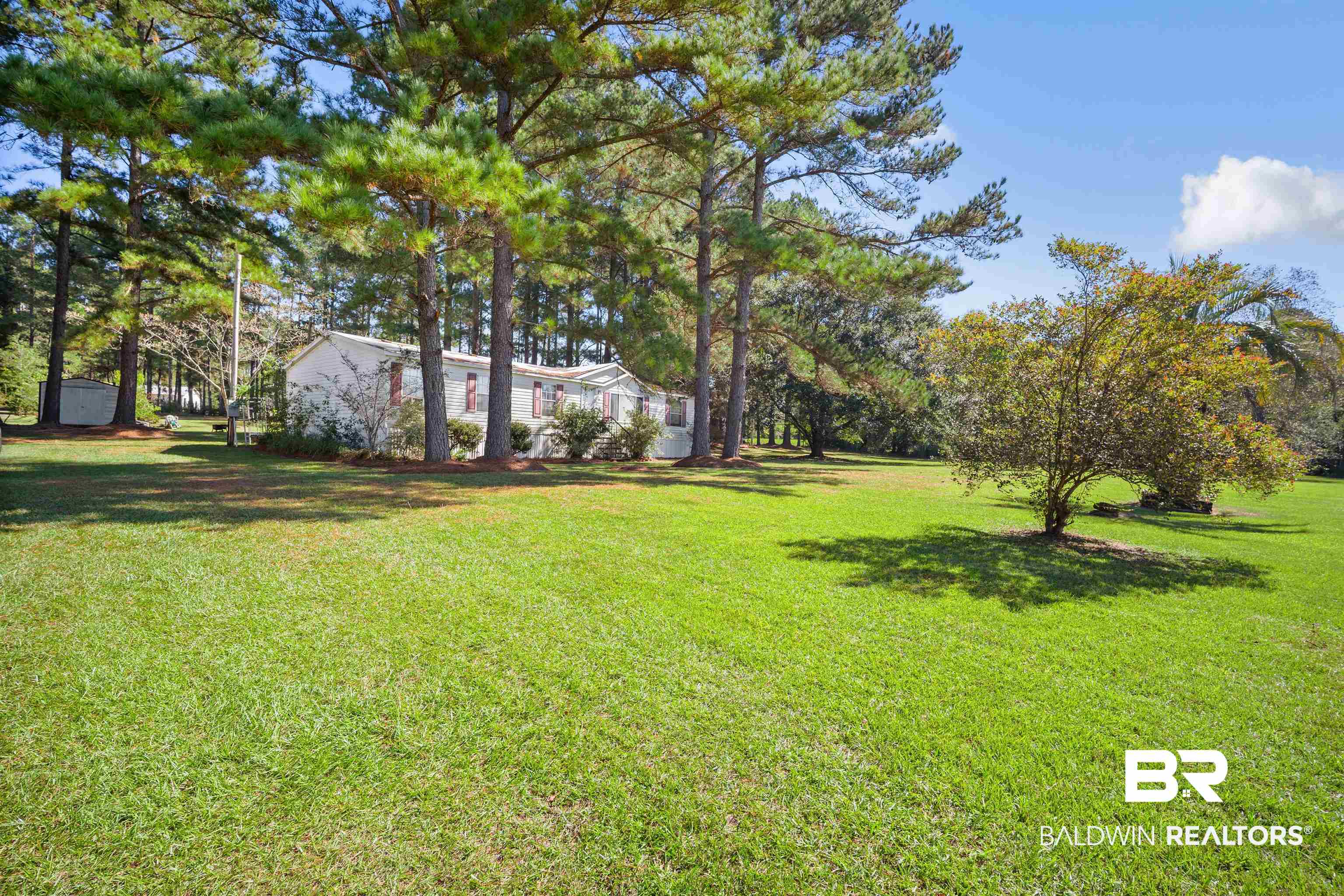 23700 Cumberland Road Robertsdale, AL 36567 - Photo 2 of 33 View of grassy yard featuring view of wooded area