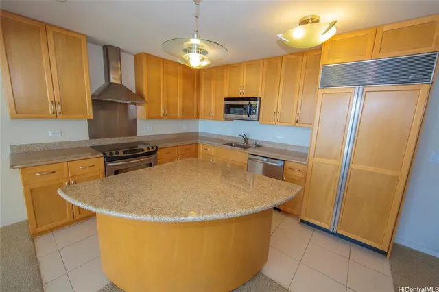 a kitchen with stainless steel appliances granite countertop a sink a stove and a refrigerator