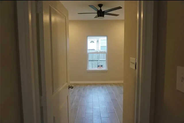 a view of an empty room and wooden floor