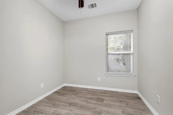 an empty room with windows and closet