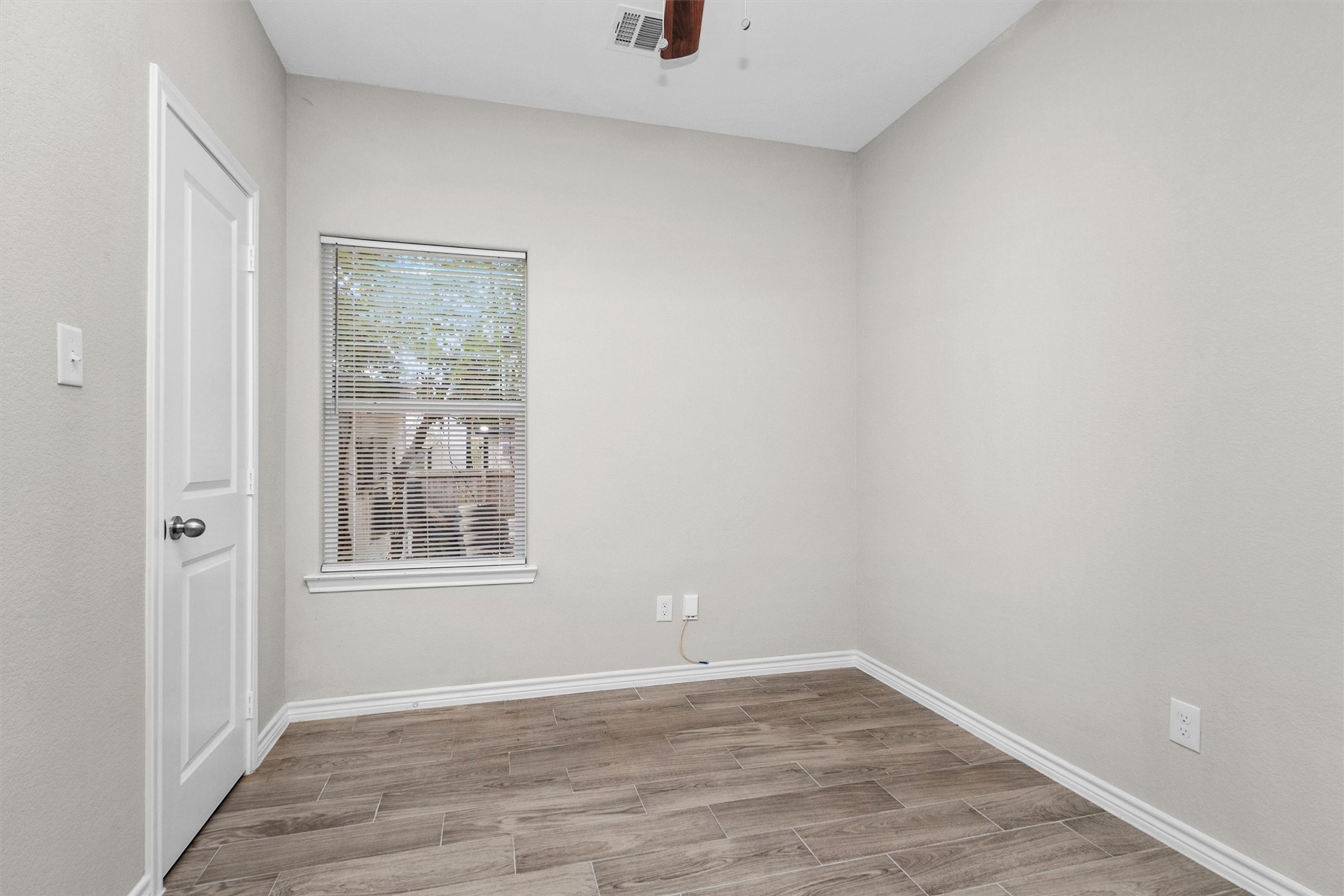 16706 East Hammon Montgomery, TX 77316 - Photo 16 of 26 a view of an empty room with wooden floor and a window