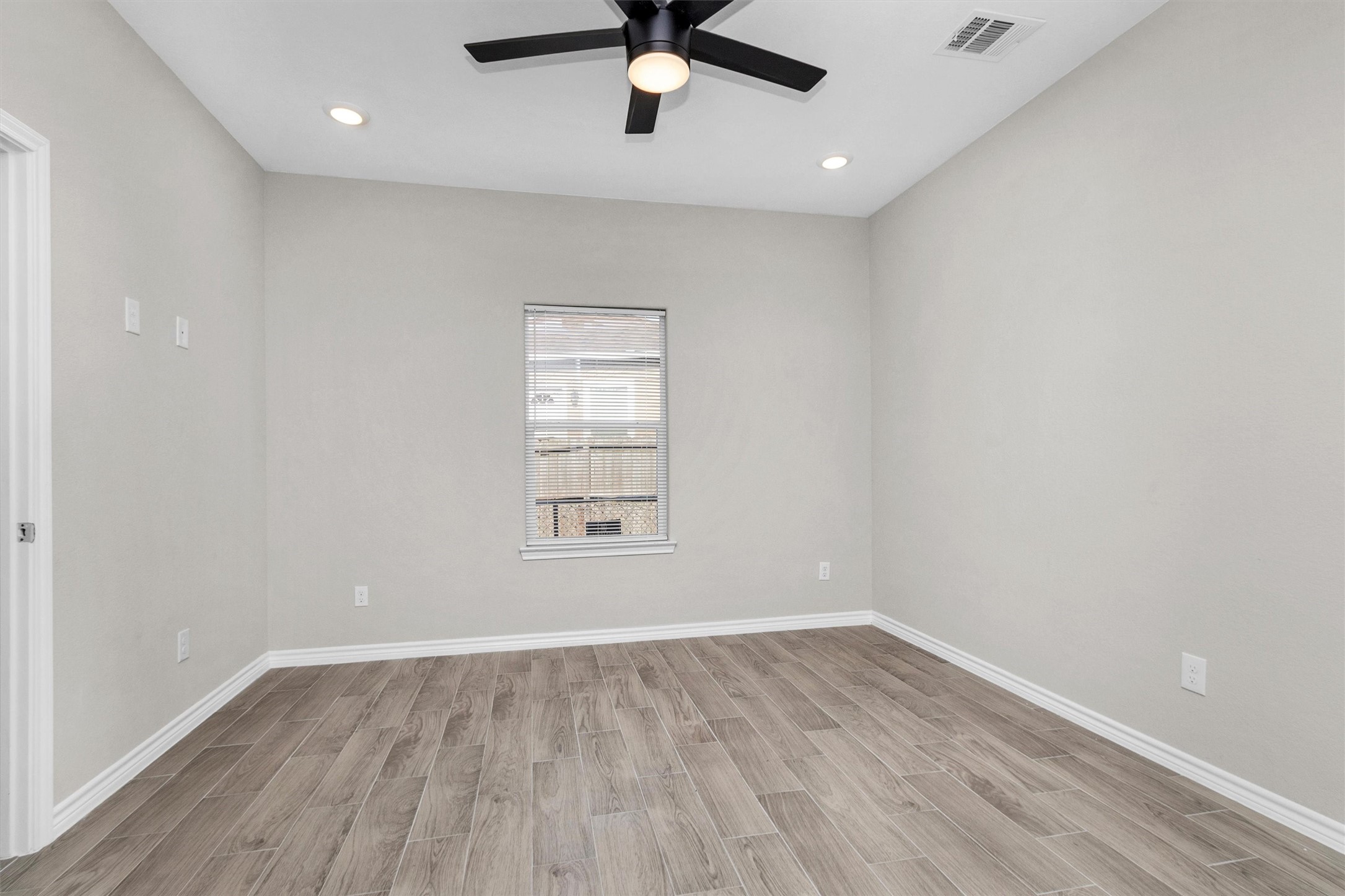 16706 East Hammon Montgomery, TX 77316 - Photo 20 of 26 an empty room with wooden floor fan and windows