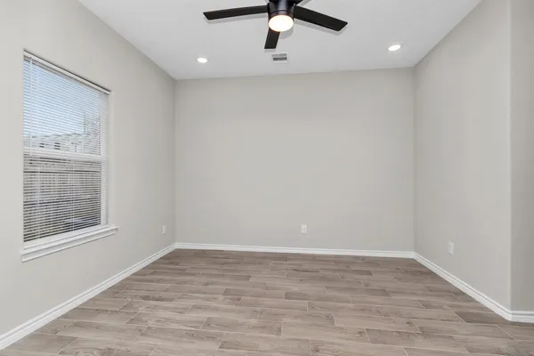 wooden floor in an empty room with a window