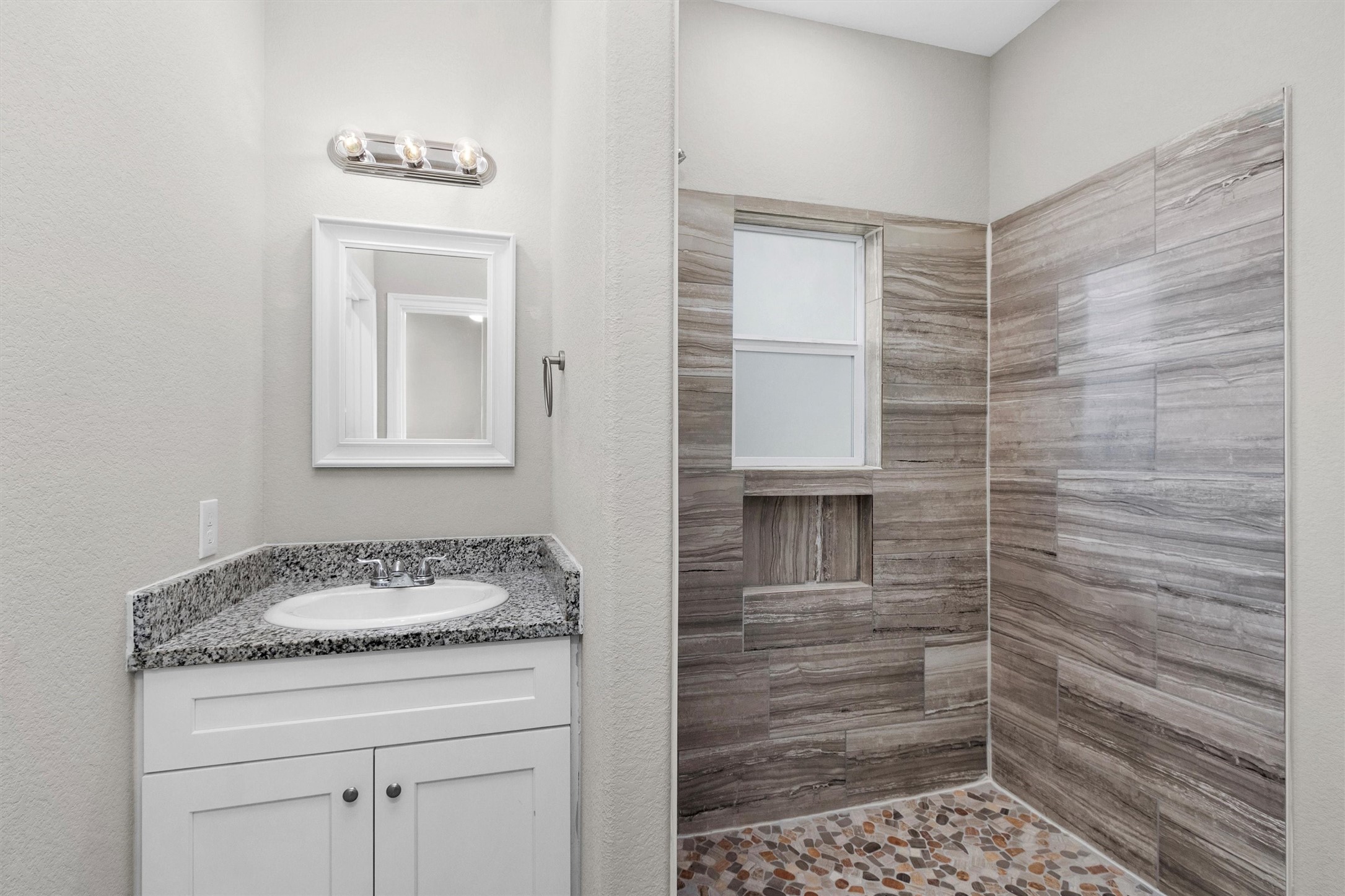 16706 East Hammon Montgomery, TX 77316 - Photo 23 of 26 a bathroom with a granite countertop sink a vanity and a shower