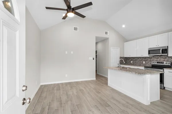 a view of a kitchen with electric appliances