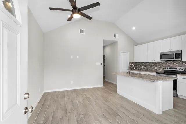 a view of a kitchen with electric appliances