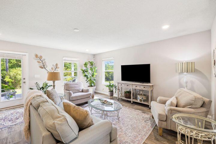 144 American Court Santa Rosa Beach, FL 32459 - Photo 11 of 19 a living room with furniture and a flat screen tv
