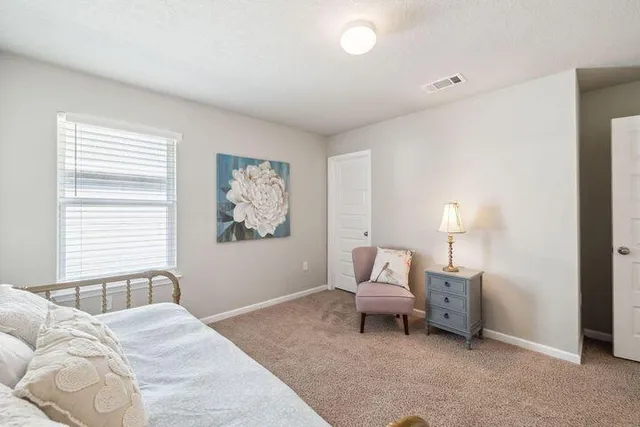 a bedroom with a bed and a window