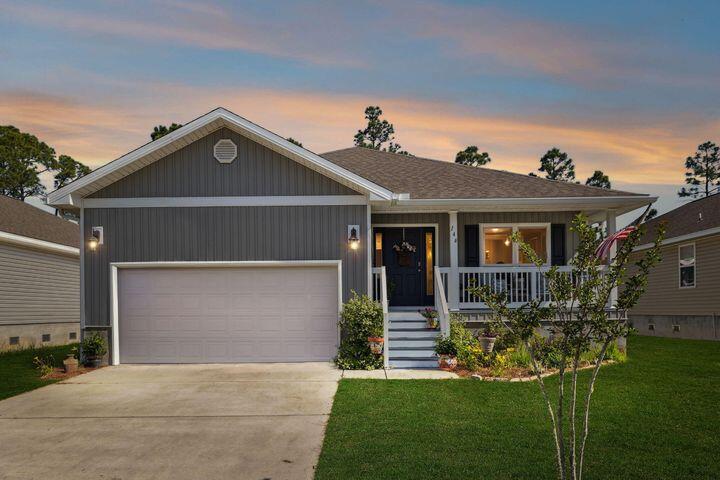 144 American Court Santa Rosa Beach, FL 32459 - Photo 2 of 19 a front view of a house with a yard