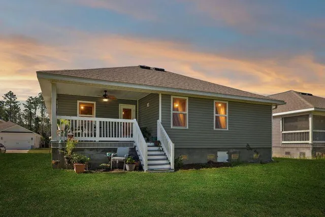 a front view of a house with a garden