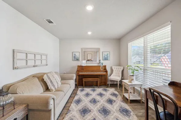 a bedroom with furniture and a large window