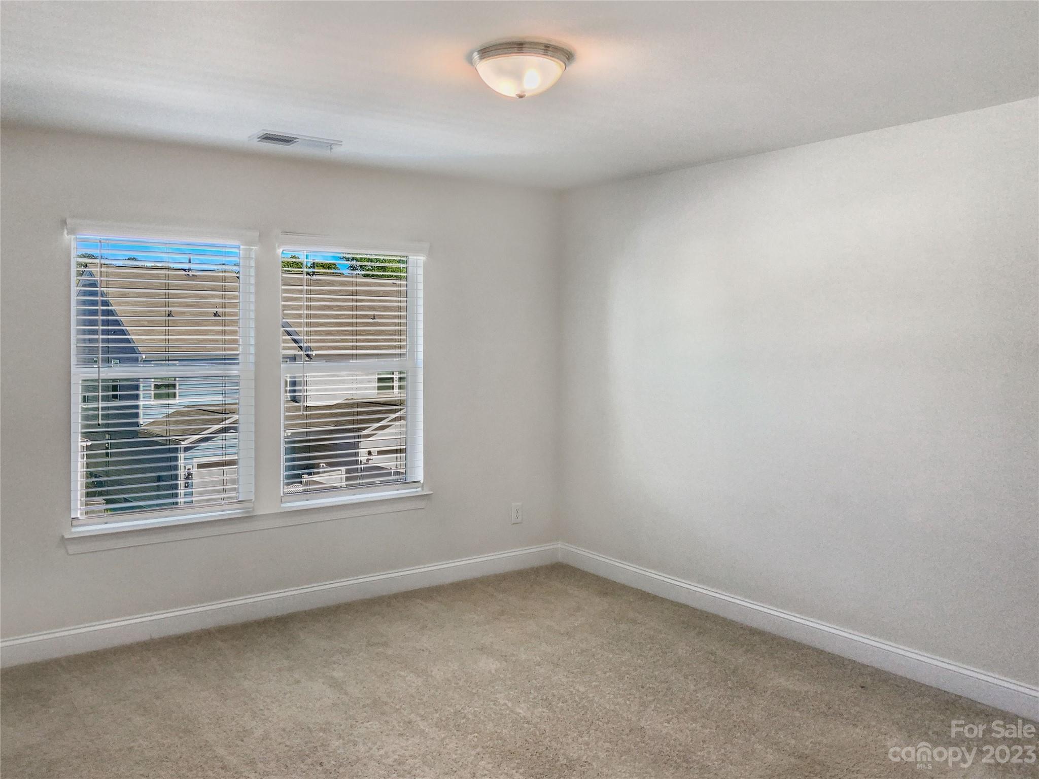 208 Waterlynn Ridge Road, Unit B Mooresville, NC 28117 - Photo 13 of 21 an empty room with a window