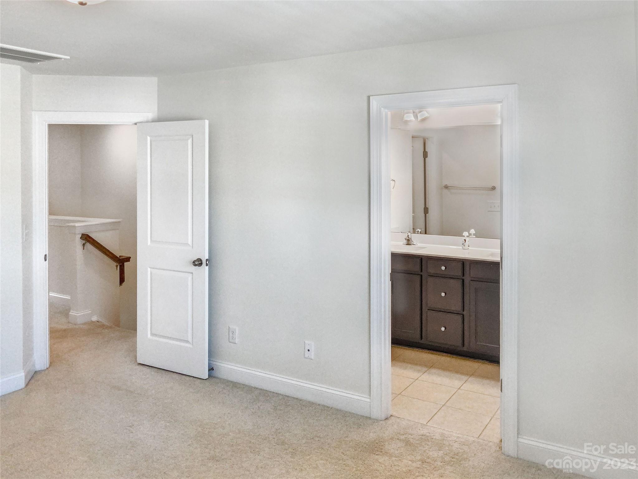 208 Waterlynn Ridge Road, Unit B Mooresville, NC 28117 - Photo 14 of 21 a view of an empty room with closet and mirror