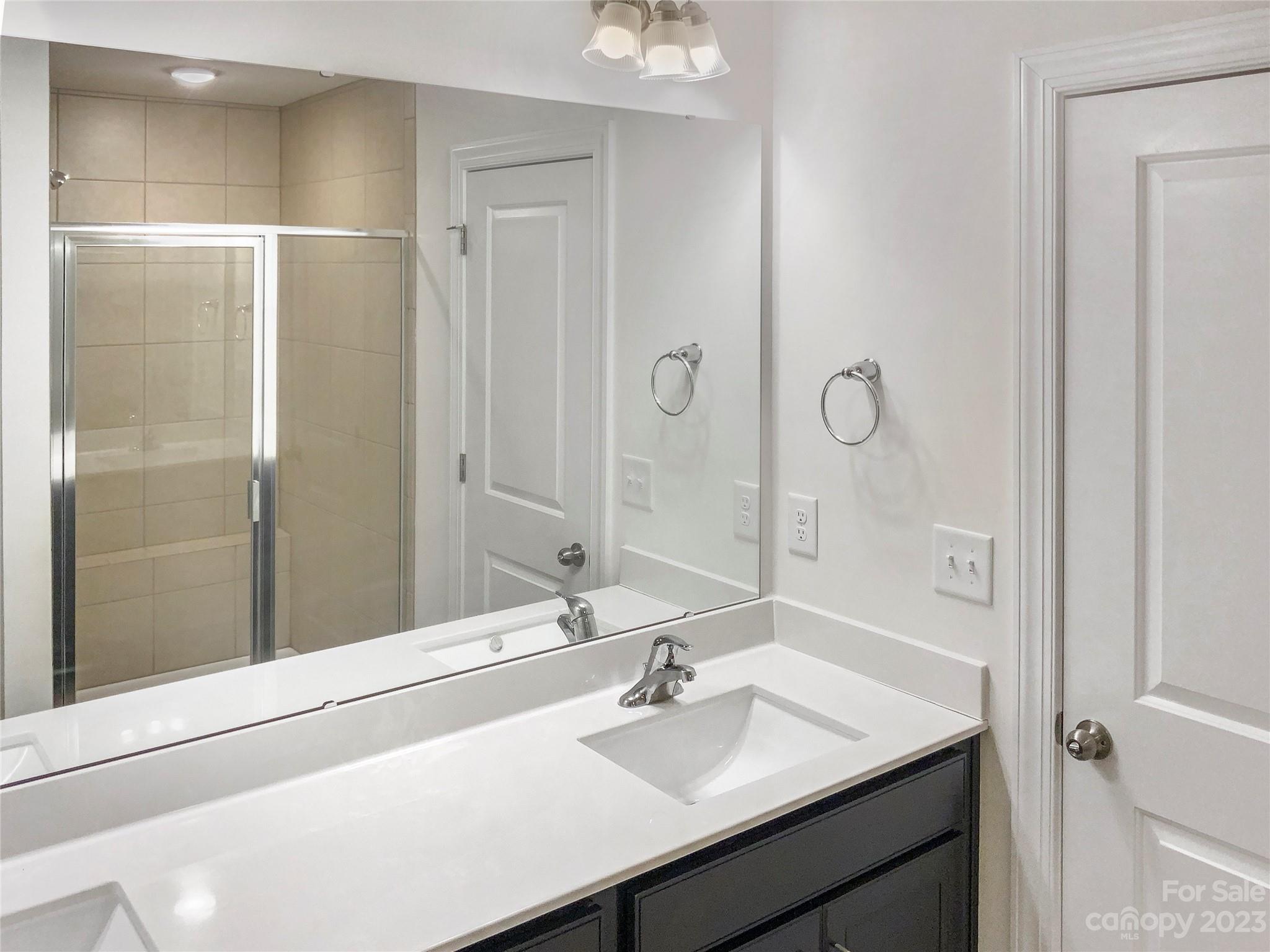 208 Waterlynn Ridge Road, Unit B Mooresville, NC 28117 - Photo 17 of 21 a bathroom with a sink and a mirror