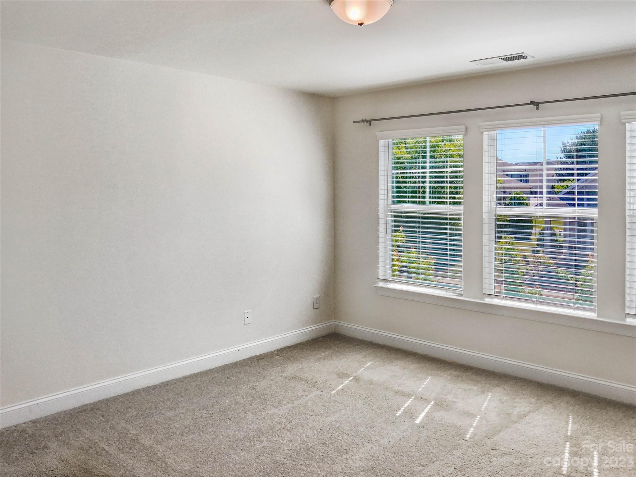 208 Waterlynn Ridge Road, Unit B Mooresville, NC 28117 - Photo 5 of 21 an empty room with a window