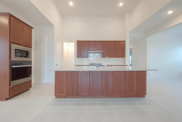 a kitchen with a cabinets and stainless steel appliances