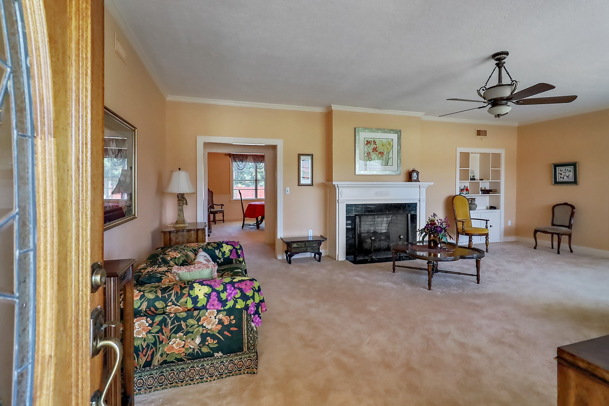 405 Park Street Anahuac, TX 77514 - Photo 7 of 37 Entering through the front glassed in porch, you're welcomed into this spacious formal living room with built ins and a fireplace.