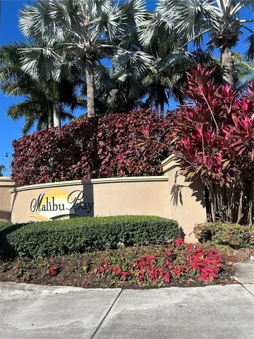 a street sign that is sitting in front of flowers