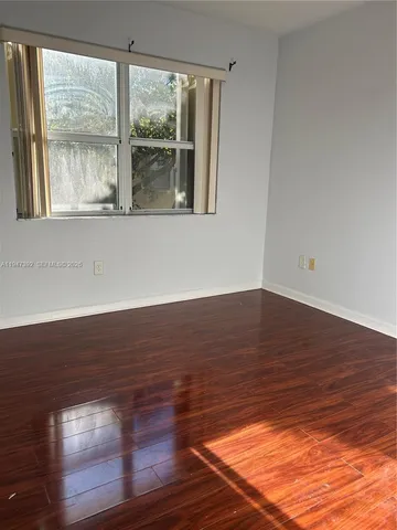 a view of wooden floor and windows in a room