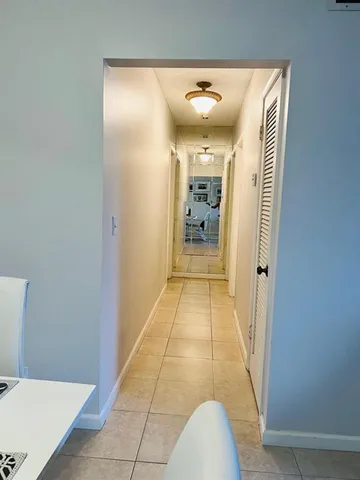 a view of hallway with bathroom